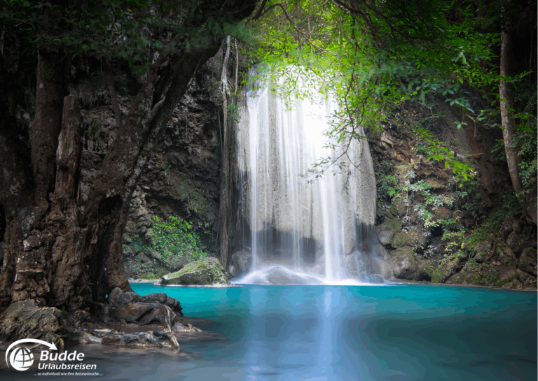 Urlaubsreise Paradies: Erawan Wasserfall mit klarem Wasser in einer Dschungelumgebung, umgeben von Bäumen.