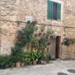 Historisches Gebäude mit vielen Blumentöpfen in Valldemossa