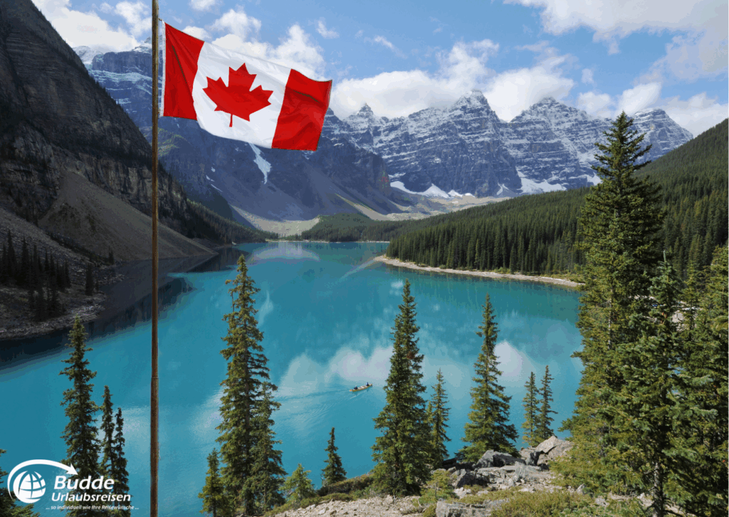 Diamir Erlebnisreisen Kanadische Flagge weht vor einem klaren See und Bergen in Kanada. - buchbar im Reisebüro Budde Urlaubseisen