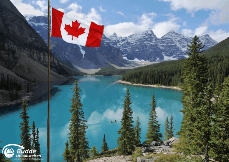 Diamir Erlebnisreisen Kanadische Flagge weht vor einem klaren See und Bergen in Kanada. - buchbar im Reisebüro Budde Urlaubseisen