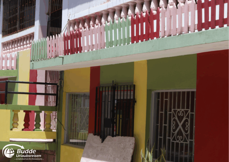 Jamaica Urlaub: Fassaden eines Gebäudes in Jamaika mit bunten Farben und Balkonen. - buchbar im Reisebüro Budde Urlaubseisen