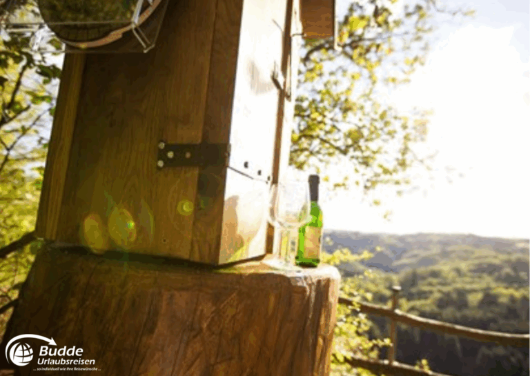 Urlaub Bad Kreuznach: Ein Holzstand mit einer Flasche auf einem Tisch im Freien, umgeben von Bäumen und Landschaft. - buchbar im Reisebüro Budde Urlaubseisen